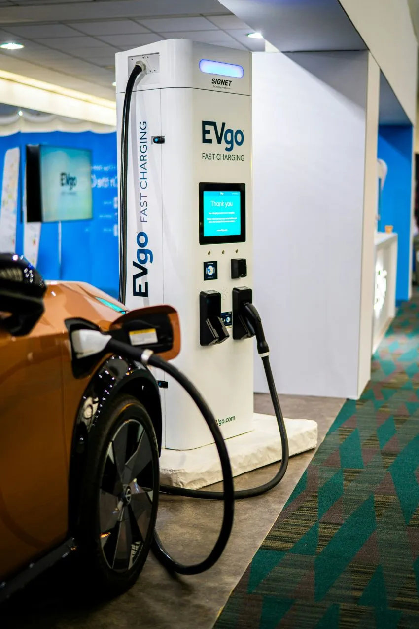Electric car charging at a fast charging station indoors.