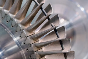 Close-up detail of individual metal turbine blades showing the fir-tree root fixation